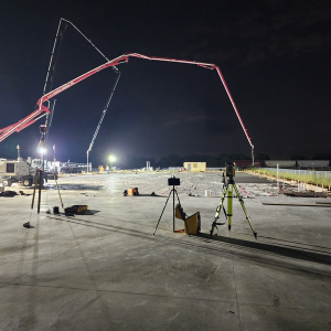 Concrete foundation layout with laser survey equipment at night